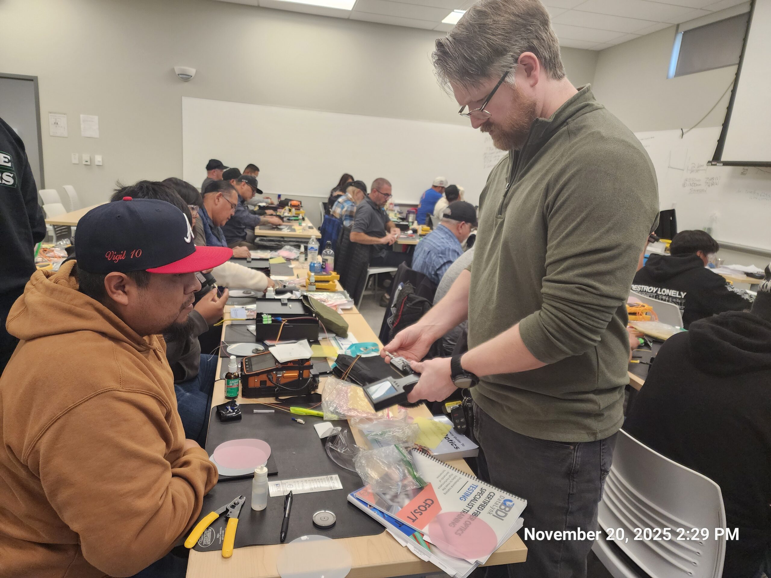 Fiber optic training classroom with students working at splicing stations